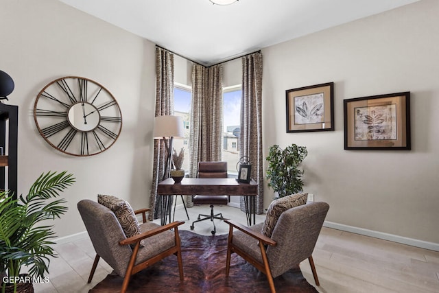 home office with light hardwood / wood-style flooring