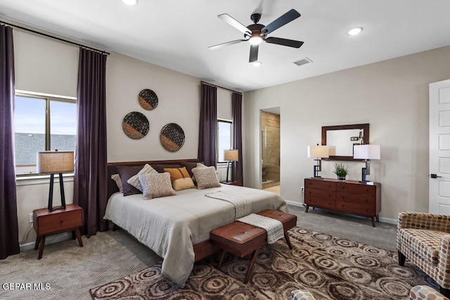 bedroom with carpet flooring, ceiling fan, a water view, and ensuite bathroom