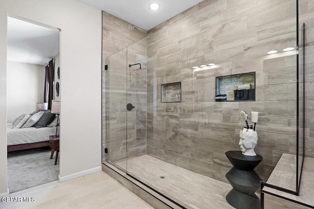 bathroom featuring toilet and a shower with shower door