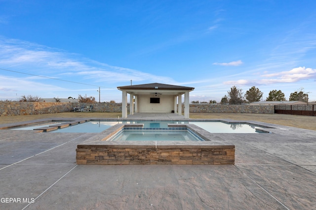 view of swimming pool featuring an in ground hot tub, ceiling fan, and a patio area