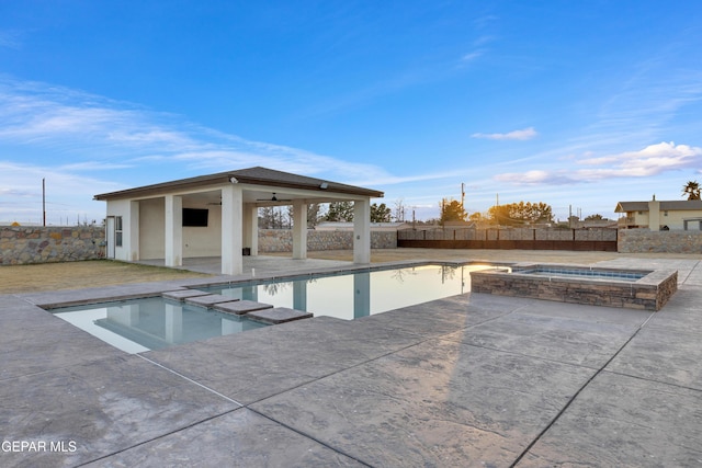 view of pool with a patio, ceiling fan, and an in ground hot tub