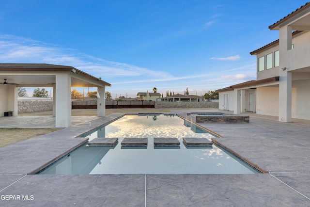 view of pool with an in ground hot tub and a patio