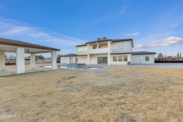 rear view of property with a yard and a patio area