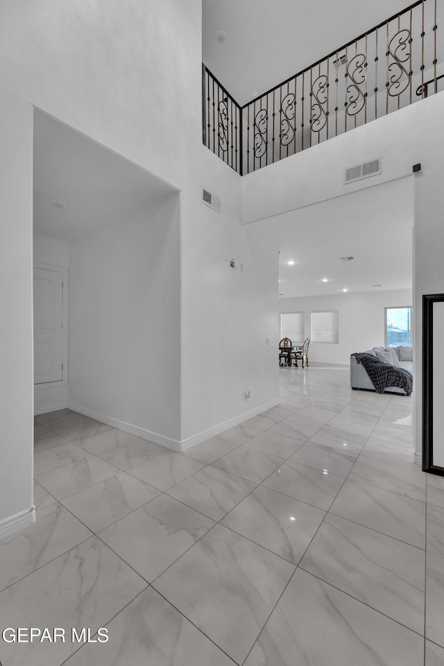 unfurnished living room with a high ceiling