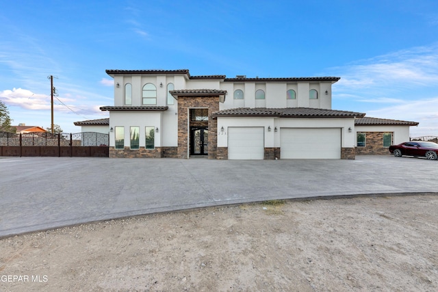 mediterranean / spanish home featuring a garage