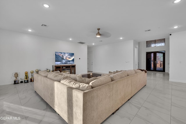 living room featuring ceiling fan and french doors