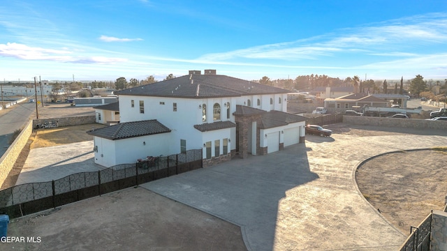 rear view of property featuring a garage