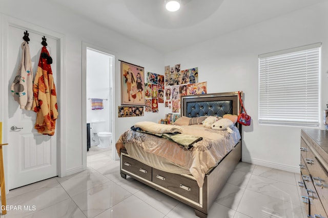 bedroom with ceiling fan and ensuite bathroom