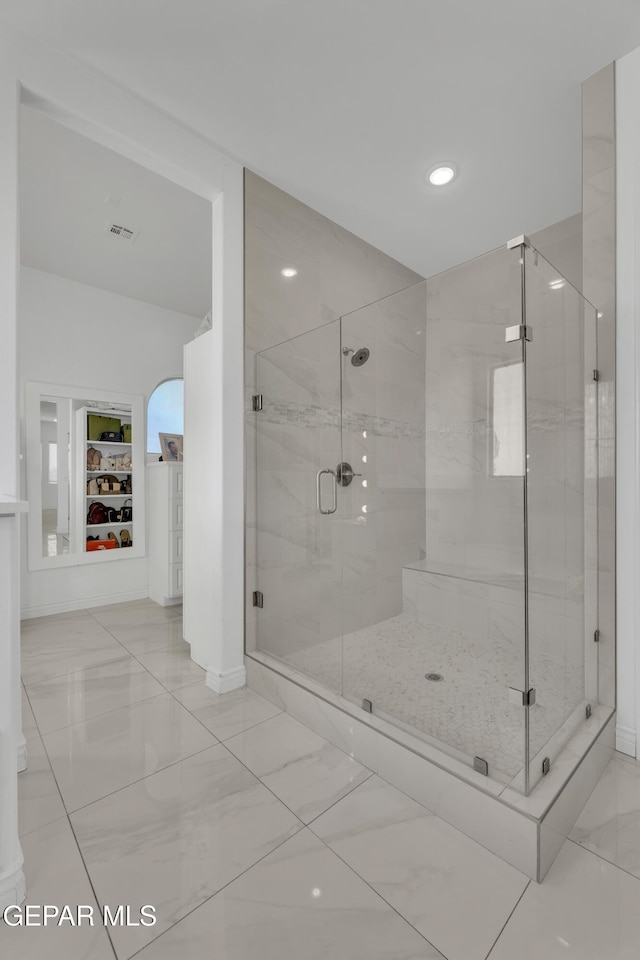 bathroom featuring a shower with shower door