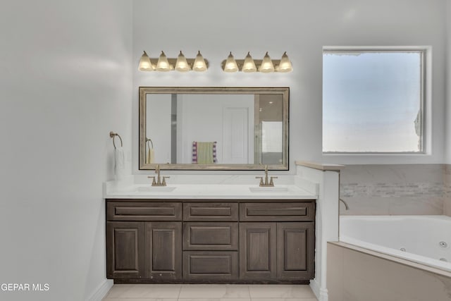 bathroom featuring vanity, tile patterned flooring, and tiled tub