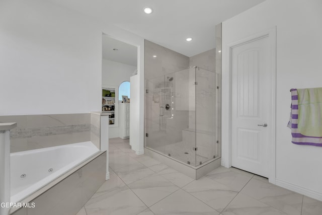 bathroom with separate shower and tub