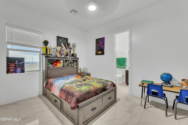 bedroom featuring ceiling fan and ensuite bathroom