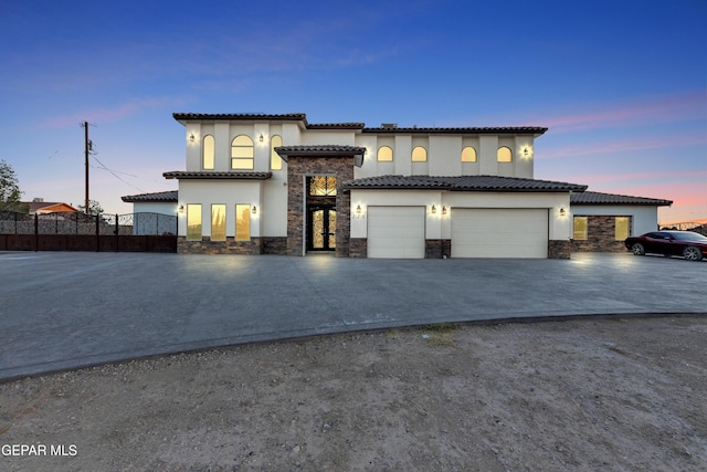 mediterranean / spanish-style house with a garage