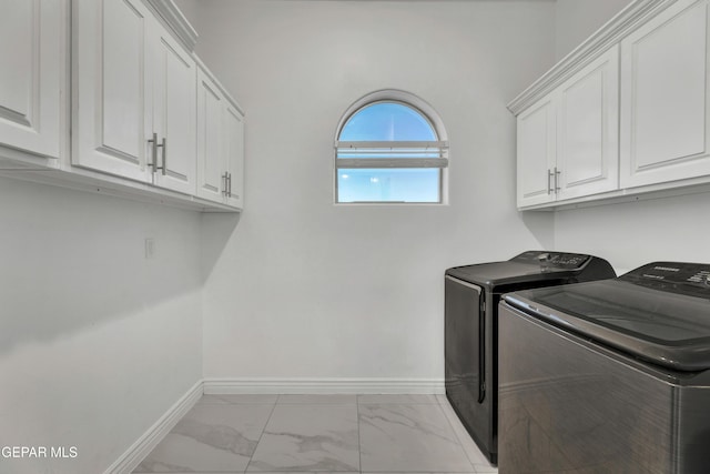 laundry room featuring cabinets and washing machine and clothes dryer