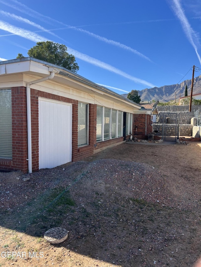 view of side of property featuring a mountain view and a garage