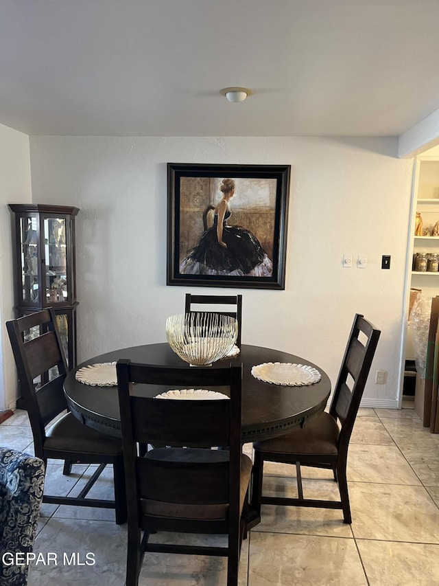 dining area featuring light tile patterned floors