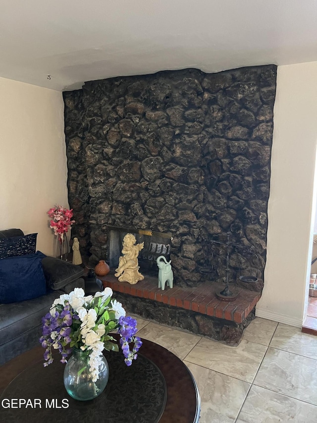 tiled living room featuring a fireplace