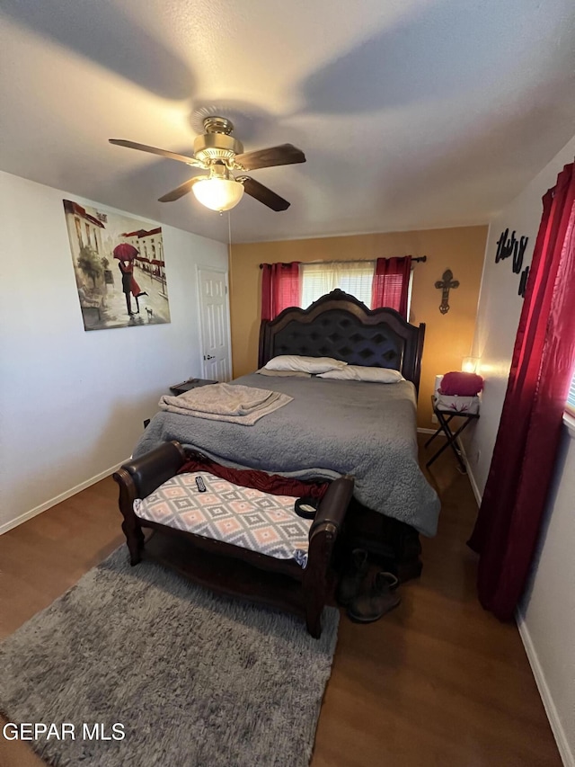 bedroom with multiple windows, wood-type flooring, and ceiling fan