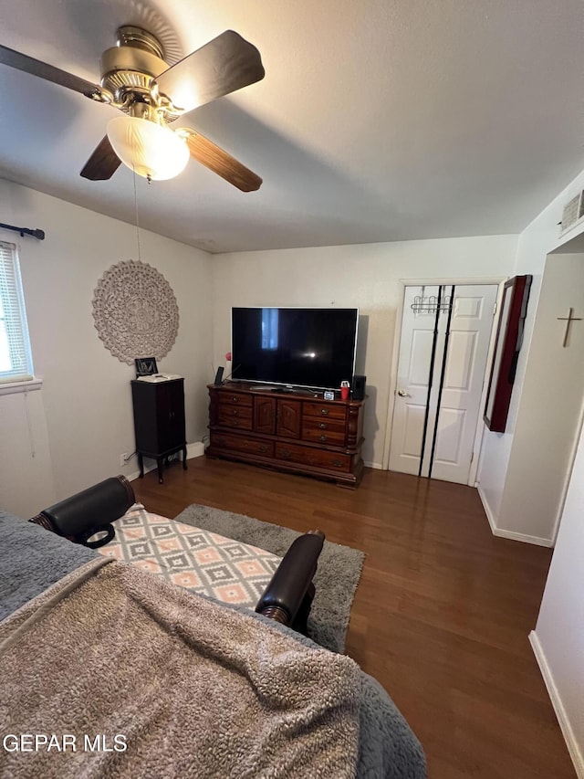 bedroom with dark hardwood / wood-style floors and ceiling fan