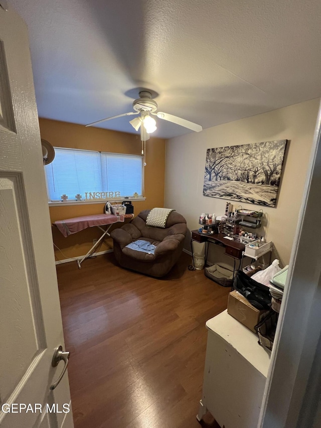 interior space featuring wood-type flooring, a textured ceiling, and ceiling fan