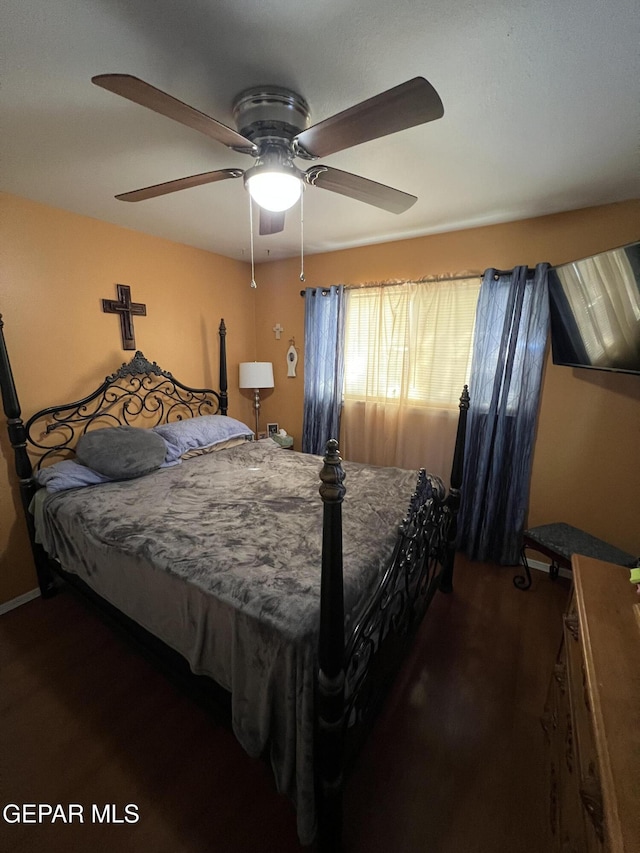 bedroom featuring dark hardwood / wood-style flooring and ceiling fan