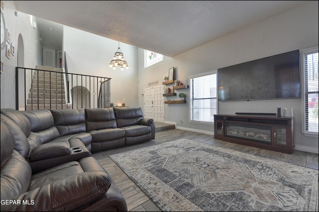 living room with hardwood / wood-style flooring and an inviting chandelier