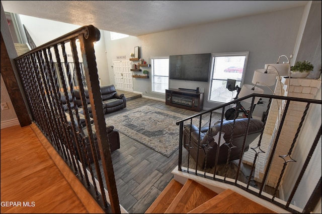 living room with wood-type flooring and a textured ceiling