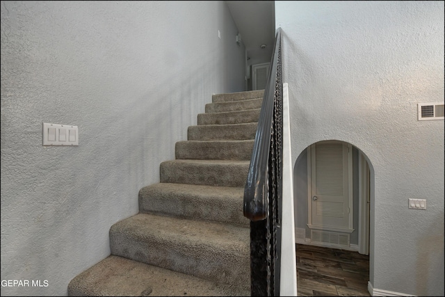 stairway with hardwood / wood-style floors