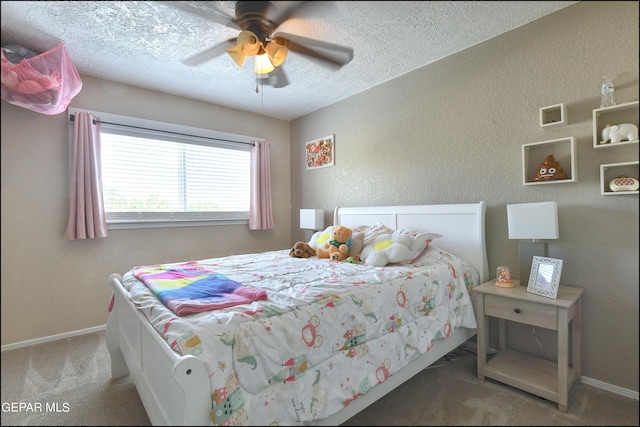 carpeted bedroom with ceiling fan and a textured ceiling