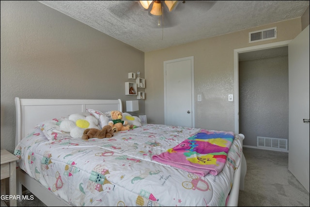 carpeted bedroom with ceiling fan and a textured ceiling