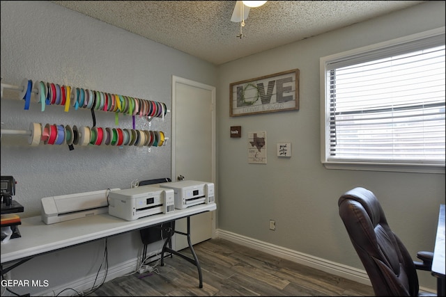 office with a textured ceiling, ceiling fan, and dark wood-type flooring