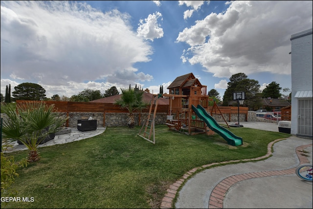 view of play area with a yard and a patio