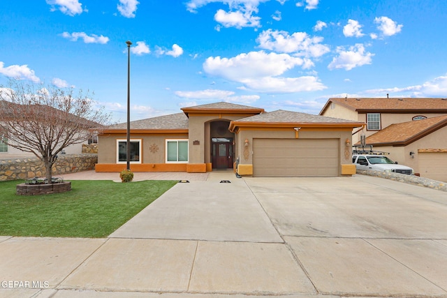 view of front of house featuring a garage and a front lawn