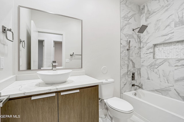 full bathroom with toilet, vanity, and tiled shower / bath