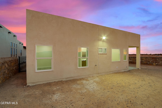 view of back house at dusk