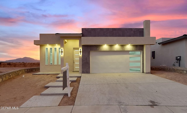 view of front facade with a mountain view and a garage