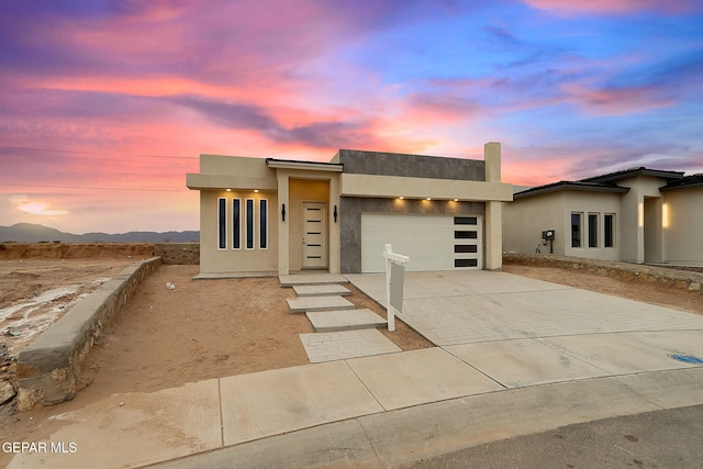 contemporary house featuring a mountain view and a garage