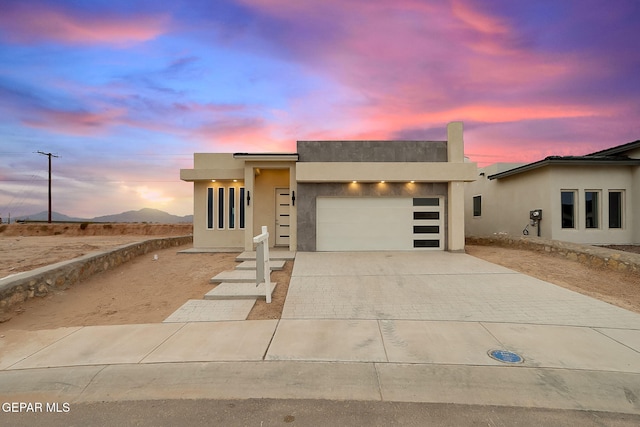 view of front of property featuring a mountain view and a garage