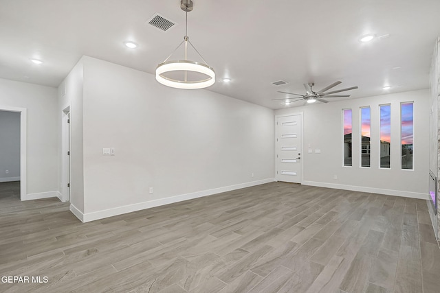 spare room featuring ceiling fan and light hardwood / wood-style flooring