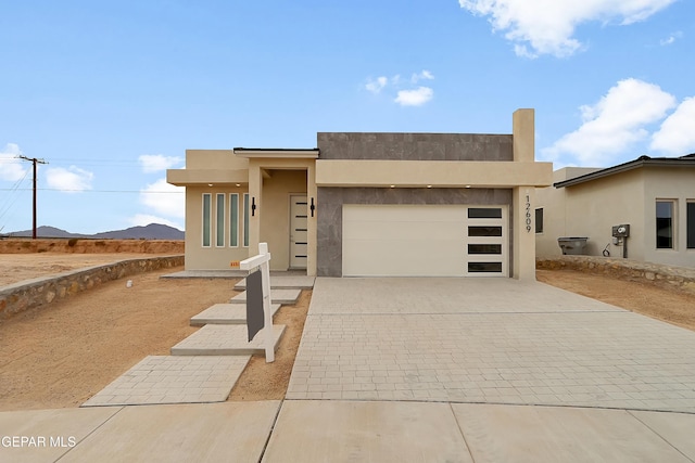 view of front facade featuring a garage and a mountain view