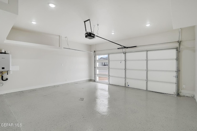 garage featuring a garage door opener and tankless water heater