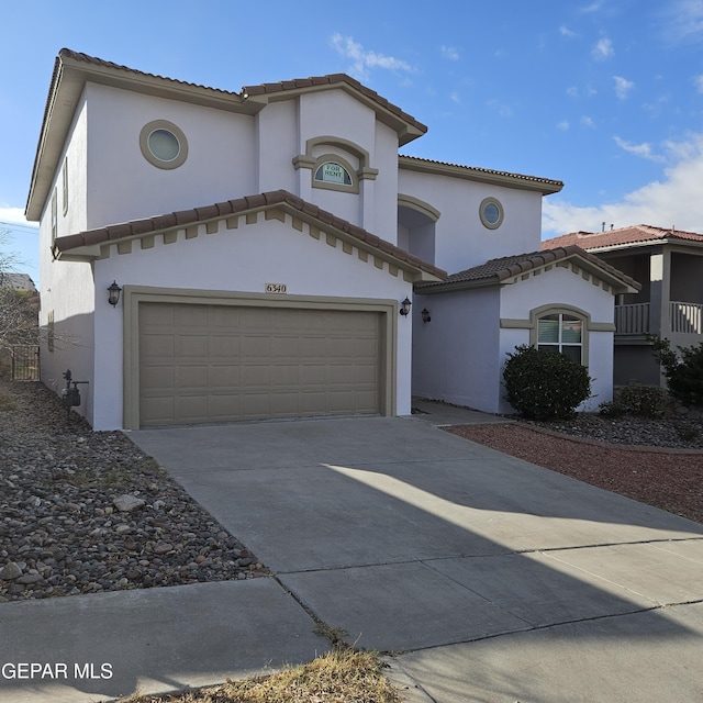 mediterranean / spanish-style home with a garage