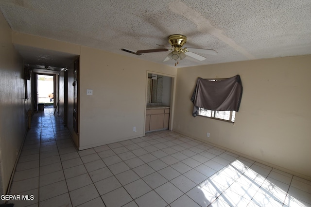 spare room featuring ceiling fan and a textured ceiling