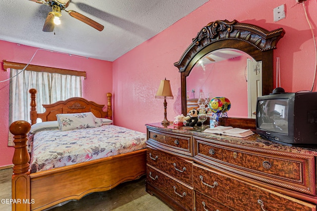 carpeted bedroom featuring ceiling fan and a textured ceiling