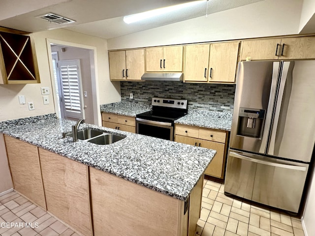 kitchen featuring backsplash, sink, appliances with stainless steel finishes, stone countertops, and kitchen peninsula