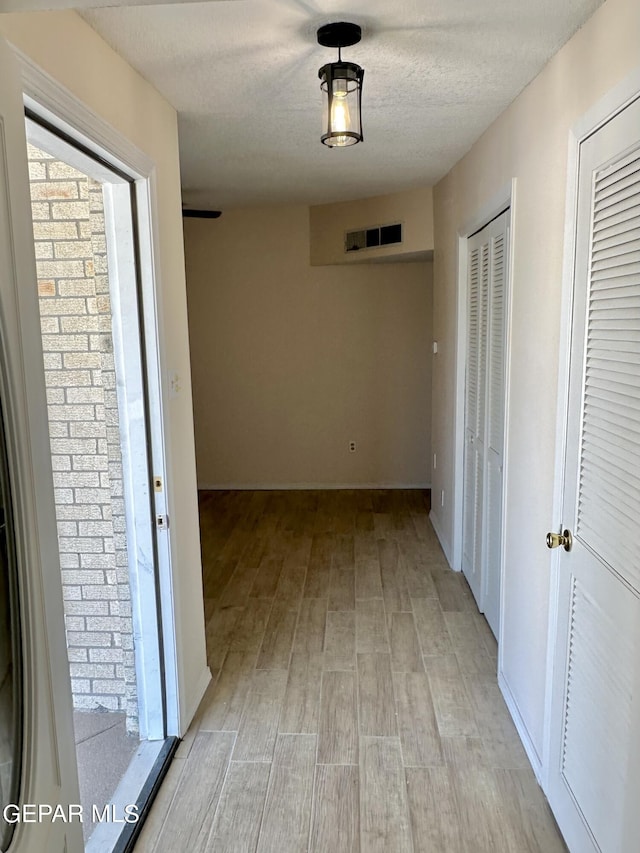 corridor with a textured ceiling