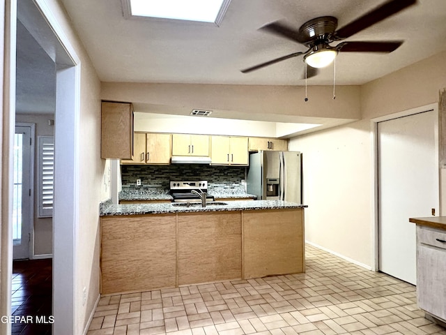 kitchen featuring ceiling fan, sink, backsplash, lofted ceiling, and appliances with stainless steel finishes