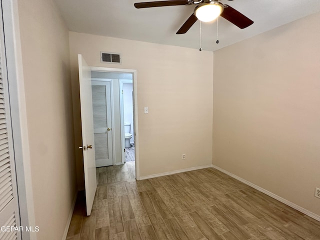 unfurnished room with ceiling fan and light wood-type flooring