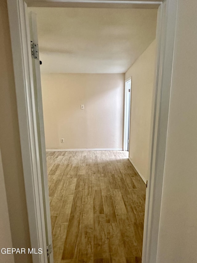 corridor with light wood-type flooring