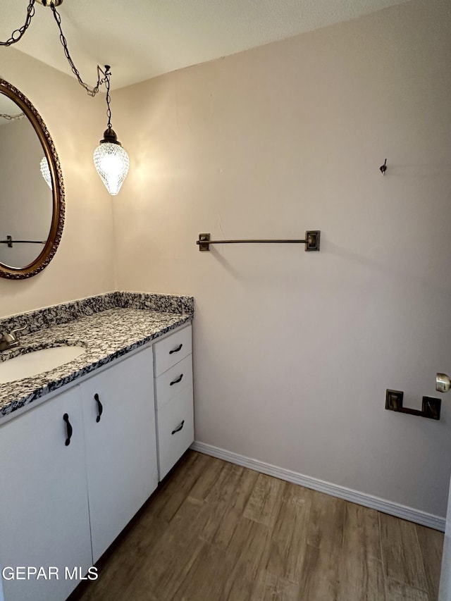 bathroom with hardwood / wood-style flooring and vanity